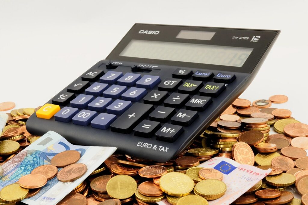 Eine Nahaufnahme von Euro-Münzen und Geldscheinen auf einem Schreibtisch symbolisiert die IWF-Prognose für Deutschland – Foto: Bru-nO / Pixabay