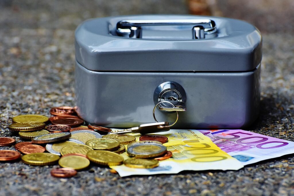 Gehaltsabrechnung und Euromünzen auf einem Schreibtisch symbolisieren die gedämpfte Lohnentwicklung bis Löhne 2029 wieder stärker steigen – Foto: Alexas_Fotos / Pixabay