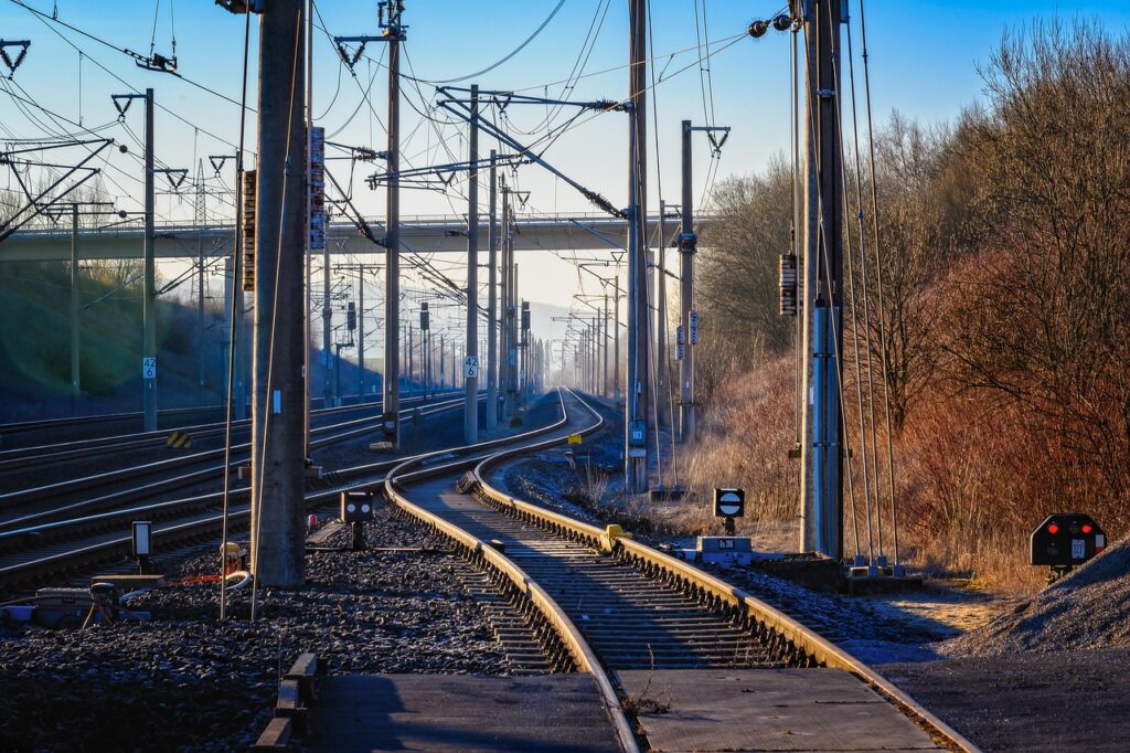 Ein Bahnsteig mit Gleisen und Ersatzbus symbolisiert die ÖBB-Zugausfälle auf der Südstrecke – Foto: Tama66 / Pixabay